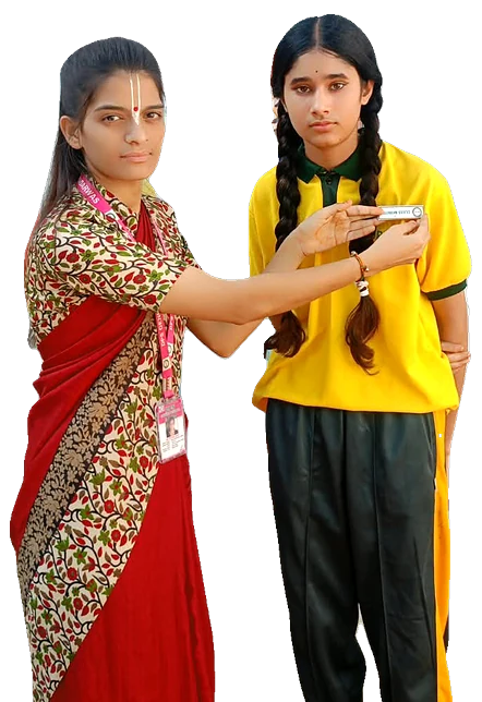 A teacher pinning a badge on a student