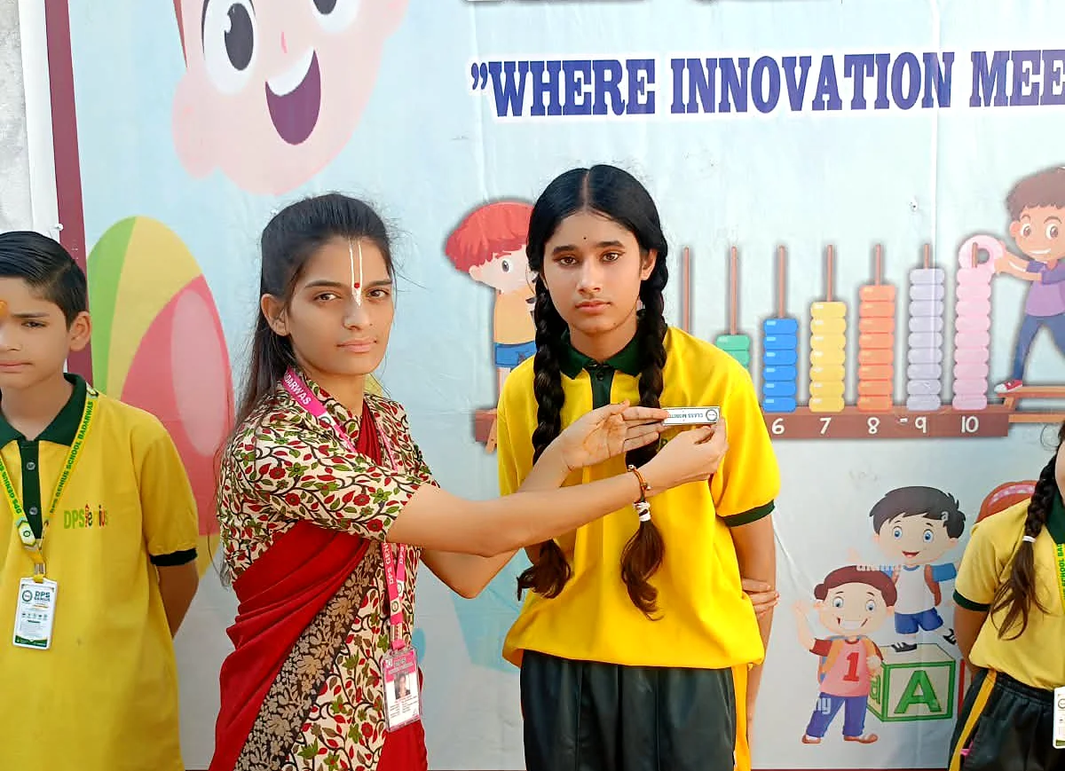 Teacher pinning a badge on a student