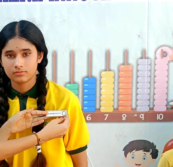A student receiving her badge